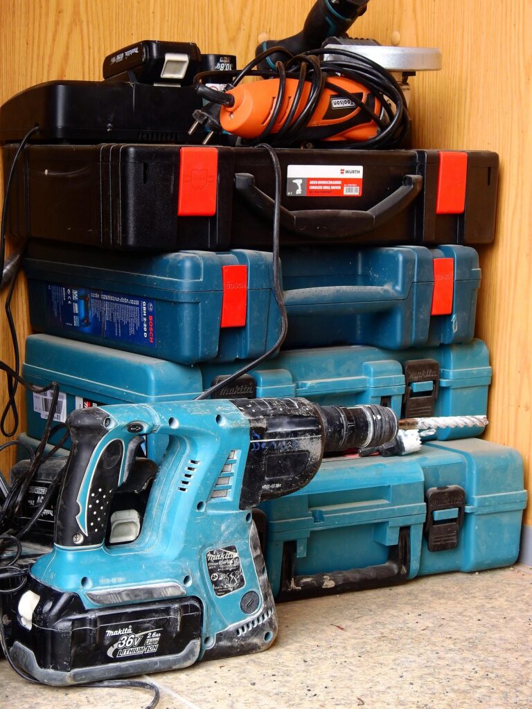 Cordless power tools including a drill, impact driver, and driver stacked together